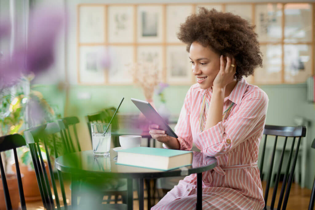 female happy on tablet device at home