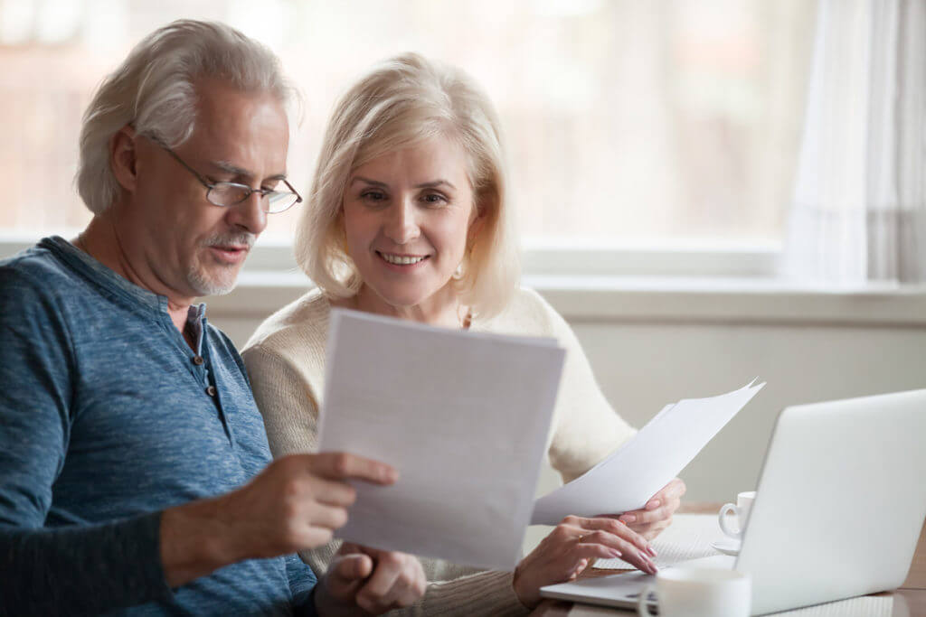 senior couple reviewing letters at home